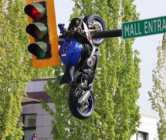 Motocicleta termina colgada de un poste de semáforo tras accidente